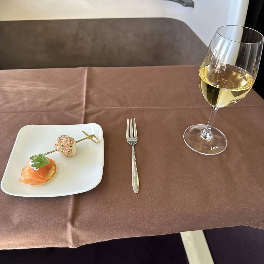Japan Airlines First class passengers who picked the Japanese menu start off with a smoked salmon appetizer and their choice of drink