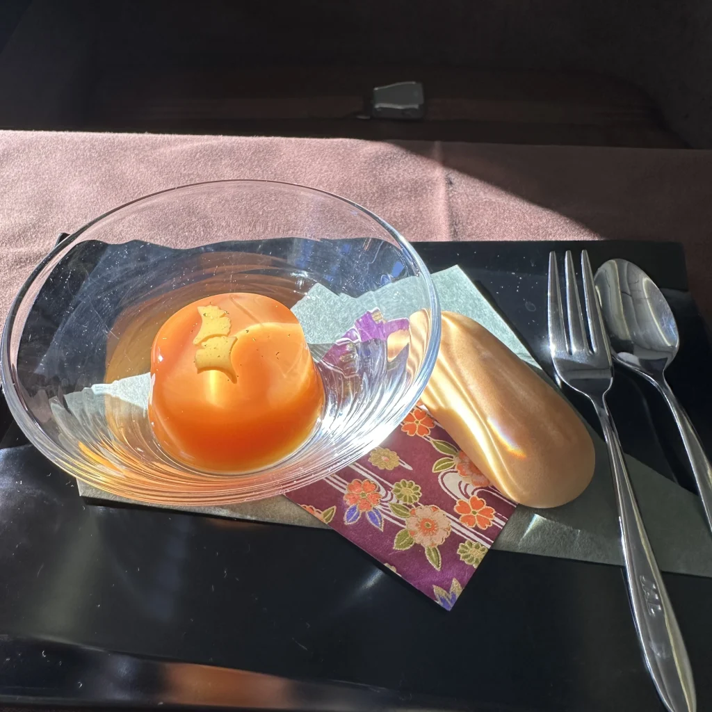 Japan Airlines first class passengers who pick the Japanese menu will receive a grapefruit jelly dess=ert