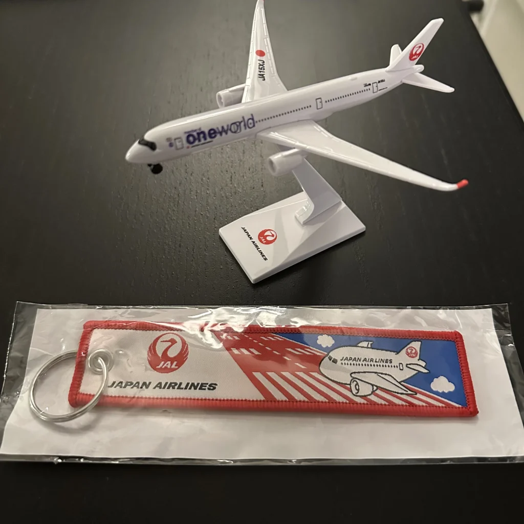 In the souvenir bag given to Japan Airlines first class passengers was a model Japan Airlines A350-900 plane, Japan Airlines pen, and Japan Airlines tag