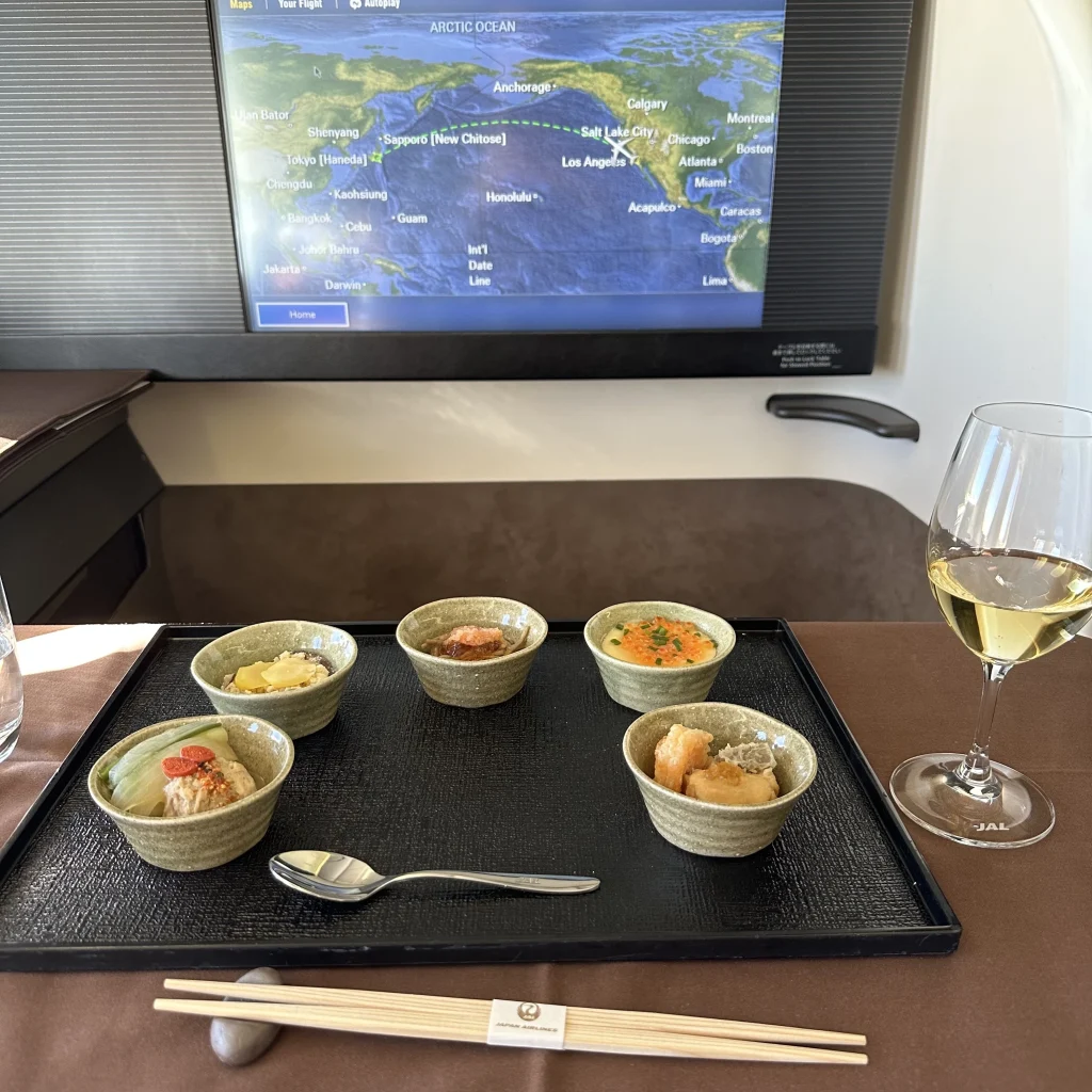 Japan Airlines First class passengers who pick the Japanese menu receive a course of 5 small plates featuring different Japanese flavors