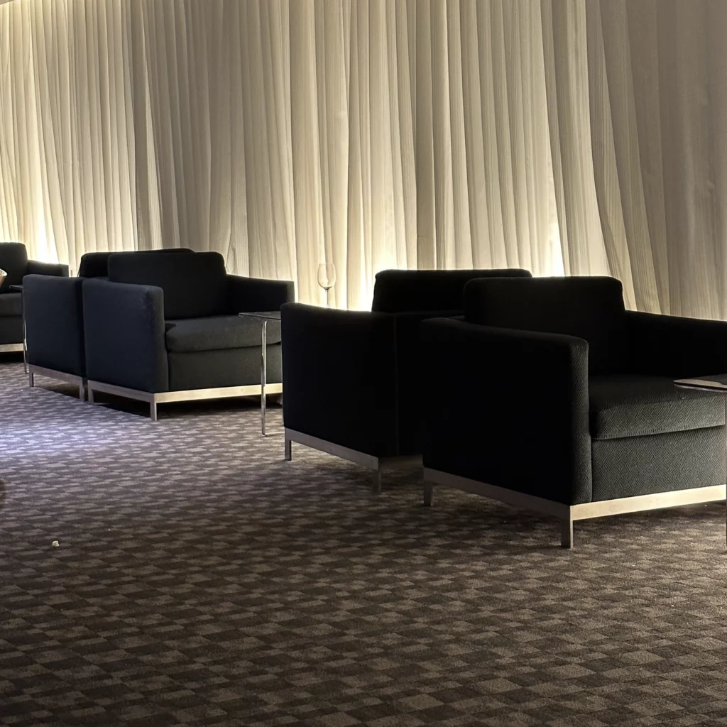 The OneWorld Lounge at LAX has lots of armchairs with coffee tables