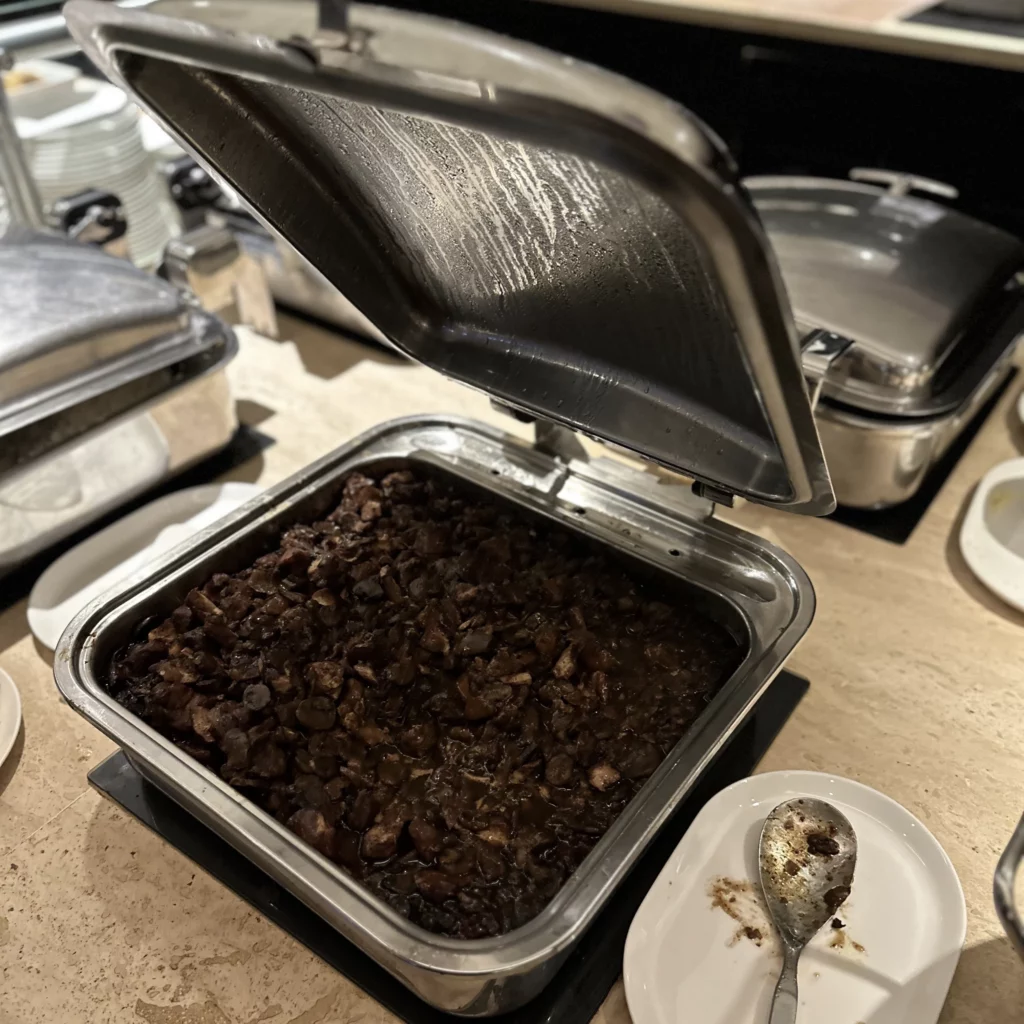 The OneWorld Lounge at LAX has hot food like beef in chafer pans 
