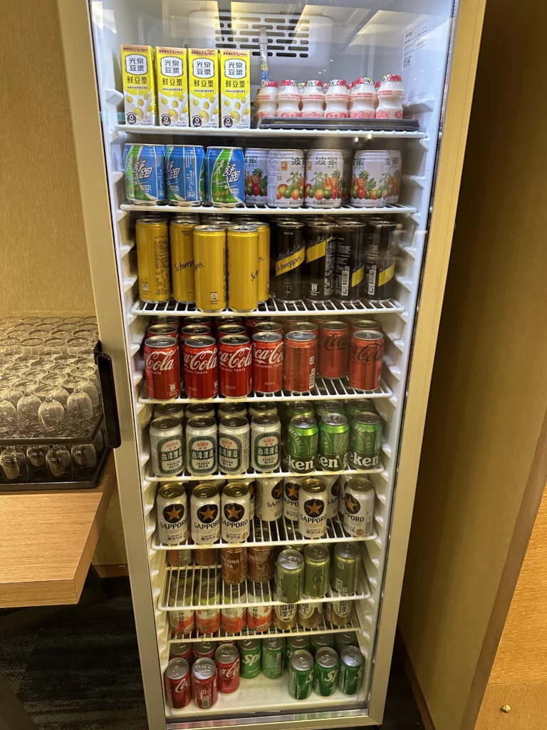 The China Airlines VIP Lounge in Terminal 2 of Taoyuan International Airport has a stocked drink fridge with sodas, teas, beer, and local drinks