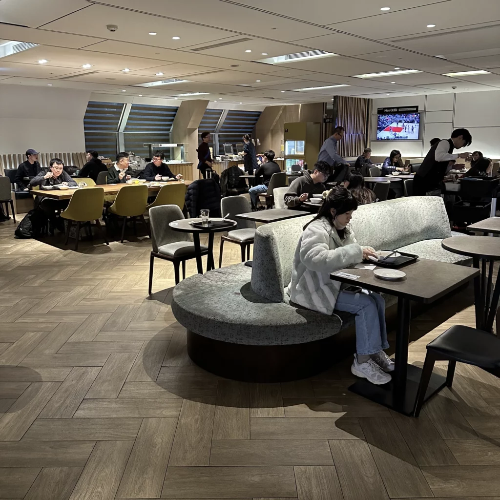 The Plaza Premium Lounge Zone A at Taoyuan International Airport in Taipei has a modern interior with a busy dining area