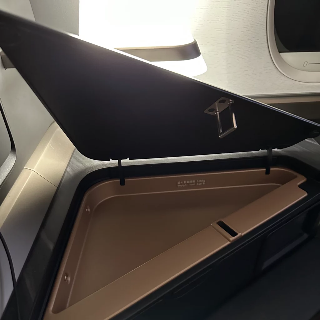 Starlux business class from Los Angeles to Taipei has a storage compartment in the side table