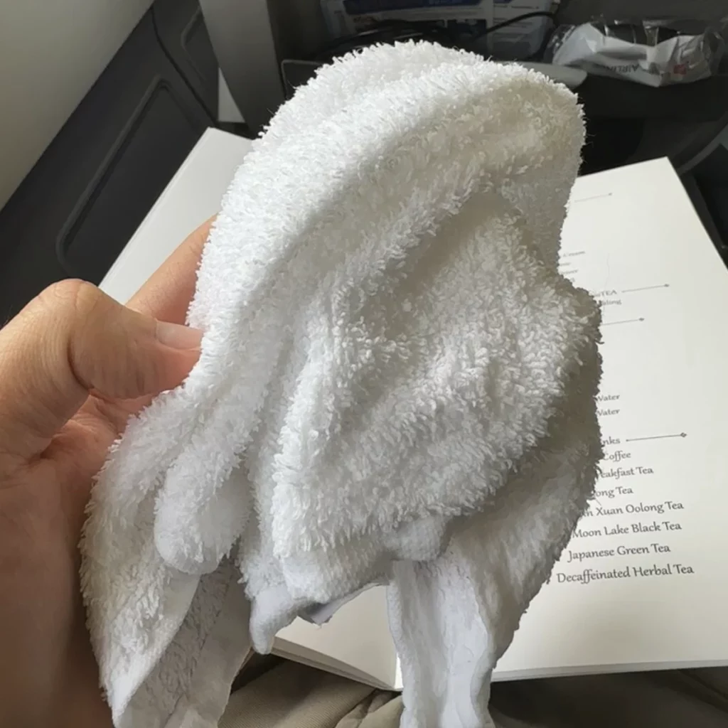 China Airlines A330-300 Business Class hands out hot towels to business class passengers before departure