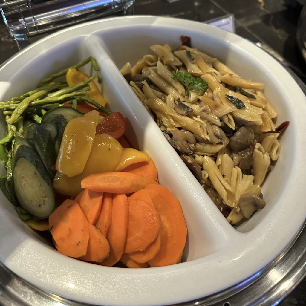 The Singapore Airlines SilverKris Lounge in Bangkok Suvarnabhumi Airport has pasta and vegetables in a hot chafing dish
