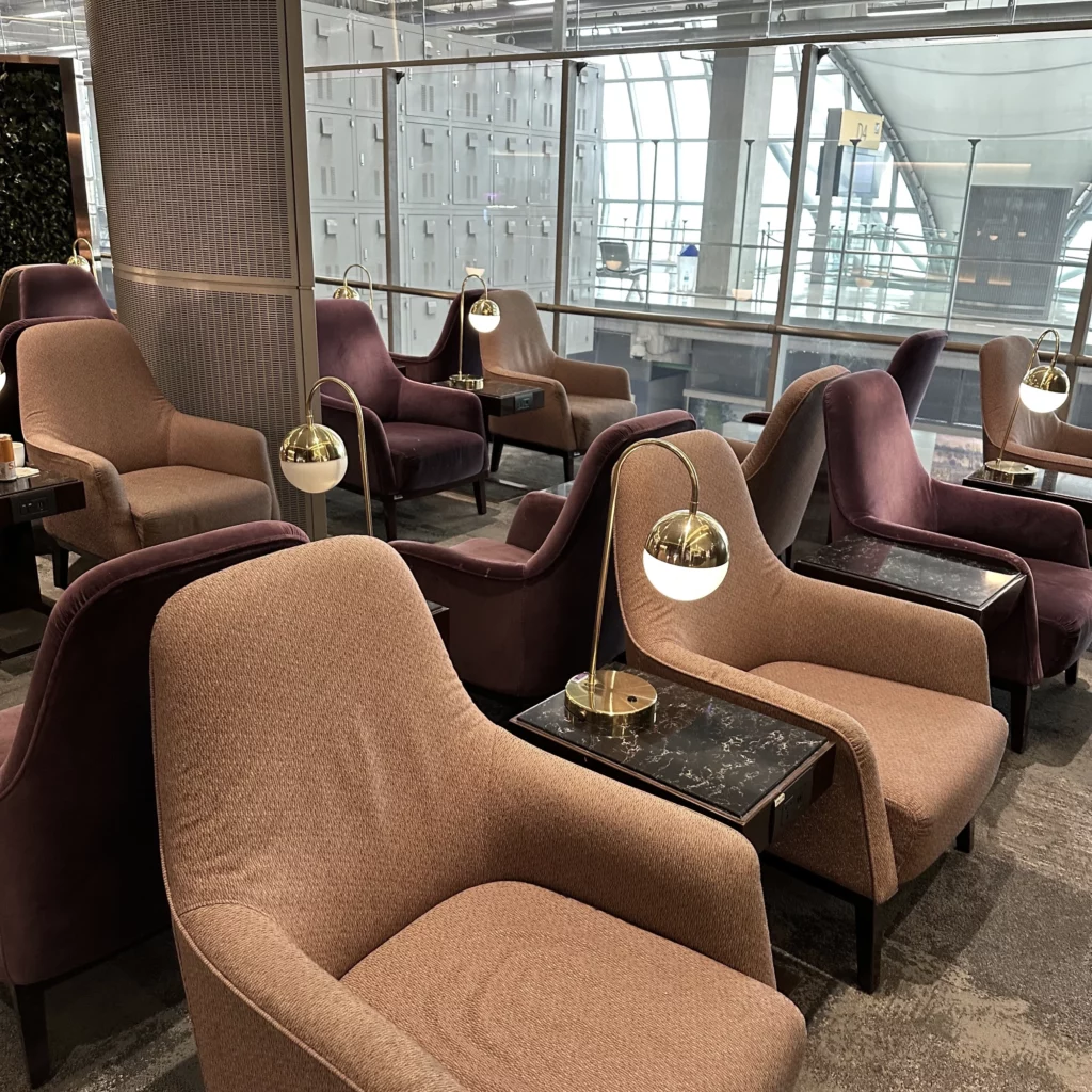 The Thai Airways Royal Orchid Prestige Business Class Lounge in Bangkok Suvarnabhumi Airport has old looking fabric lounge chairs as the main seating option